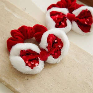 Detailed macro view of red velvet and white faux fur Christmas scrunchies with sequins