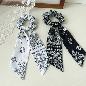 Floral print bow scrunchie set with black and white paisley patterns for hair styling