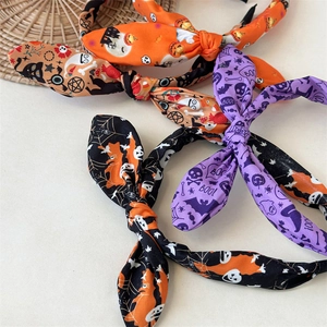 Detail of Halloween rabbit ear headbands with pumpkin and skull prints in three colors