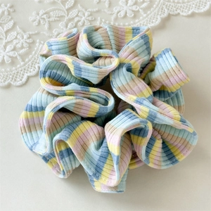 Detailed view of colorful striped scrunchies in pastel macaron colors with soft texture