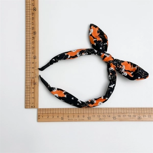 Detailed size measurement of a Halloween headband with skull and pumpkin patterns