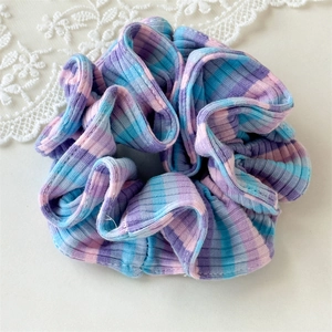 Macro view of pink and blue checkered oversized scrunchie with rib knit texture detail