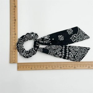Detailed size view of black paisley print hair scrunchie with long decorative ribbons