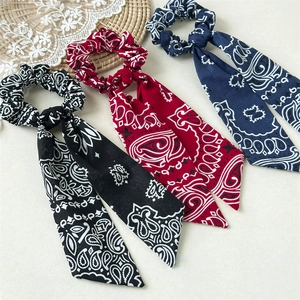 Three-piece set of paisley print bow scrunchies in black, red and navy blue fabric