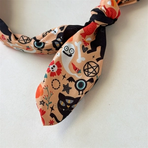 Close-up of Halloween headband fabric showing ghosts, pumpkins, and bats print