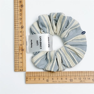 Blue and white striped scrunchie with soft pleated cotton texture and 11cm diameter