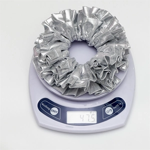 Weight measurement of a silver metallic large scrunchie showing 47.5g on a digital scale
