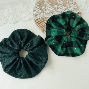 Detail of vintage velvet and plaid scrunchies with subtle silver sequins on lace