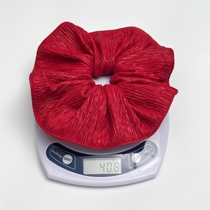 Classic red plaid oversized scrunchie hair tie weighing 40.8g on a white scale