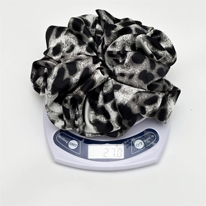 Elegant leopard print oversized hair scrunchie with silky satin texture and sleek grey patterns