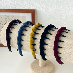 Detail showing five vintage velvet headbands with anti-slip inner tooth combs on a display