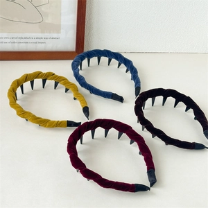 Detail of four colorful velvet headbands with non-slip inner teeth in vintage style