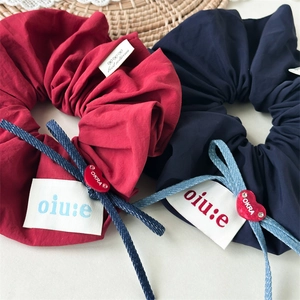 Elegant burgundy and navy blue fabric scrunchies set with chic labels and heart charms