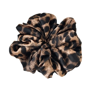 Chic leopard print satin scrunchie with silky finish for elegant ponytail styling