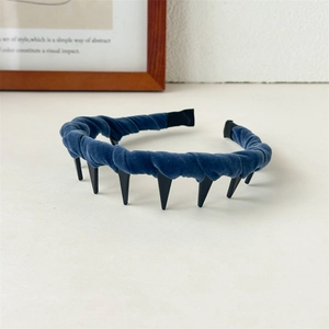 Detail shot of blue velvet headband with black shark teeth grip for hair styling