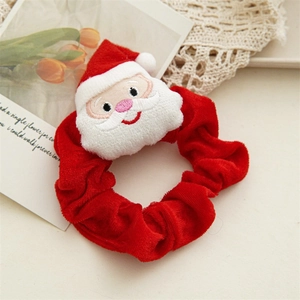 Plush Christmas scrunchie in red velvet featuring a 3D Santa Claus festive ornament