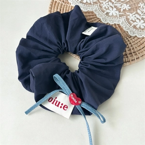 Navy blue fabric scrunchie with denim ribbons and heart charm accessory