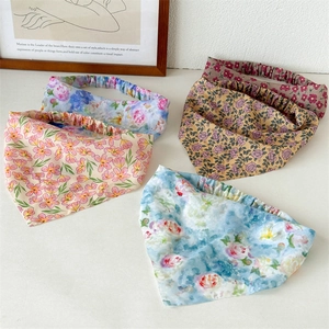 Detailed flat lay of floral patterned elastic hair scarves in various pastel colors