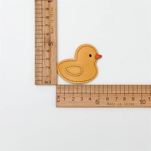 Detailed size view of yellow leather duck hair clip showing dimensions and fine stitching