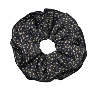 Floral print fabric scrunchie in navy blue with elegant gold heart patterns and piping