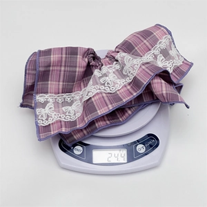 Vintage purple plaid hair scrunchie with white lace trim shown on a scale weighing 24.4g