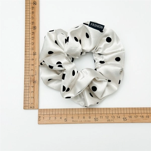 Elegant satin polka dot hair scrunchie in cream white with black fashion label detail