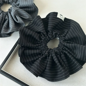 Striped oversized fabric scrunchies in black and dark grey for stylish ponytails
