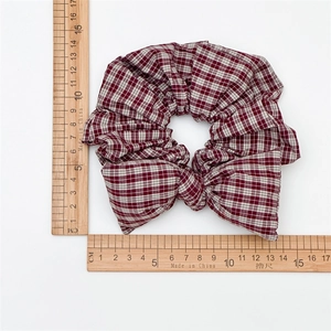 Classic red plaid oversized scrunchie with bow detail on white background measures 14cm