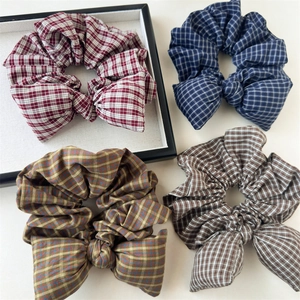 Set of four vintage plaid bow scrunchies in red, blue, and yellow fabric for ponytails