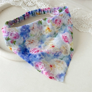 Close-up of floral pattern fabric and elastic band on a watercolor triangle hair scarf
