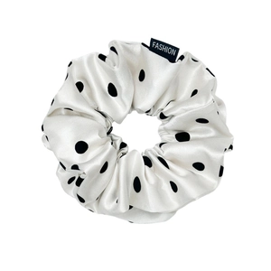 Polka dot satin scrunchie for women with elegant silk luster and fashion tag