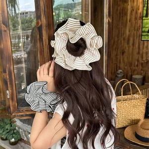 Retro striped oversized scrunchies in cream and black for elegant ponytails