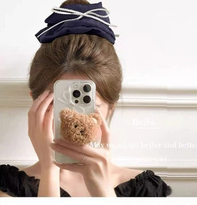 Detail of navy blue oversized scrunchie featuring elegant white pearl chain accents