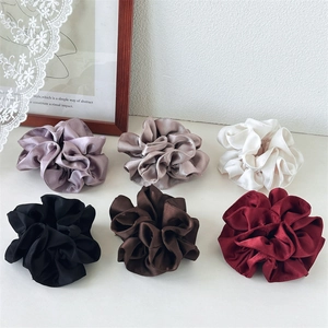 Close-up of 6-color satin scrunchie set showing soft silk texture and pleated details