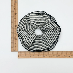 Detail shot of a 12cm striped fabric scrunchie with measuring ruler for size reference