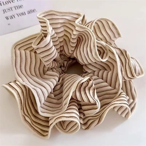 Retro striped fabric scrunchie in beige and brown with elegant pleated ruffled details