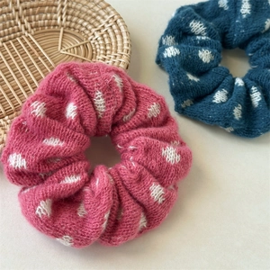 Detail of pink and navy knitted scrunchies with white jacquard diamond patterns