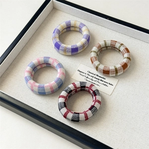 High-elastic checkered seamless hair bands in multiple colors on a stylish display tray