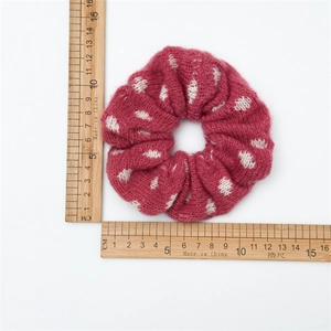 Knitted red scrunchie with white dots, soft wool blend accessory for autumn and winter