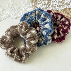 Detailed texture of French vintage knit scrunchies in blue, brown and burgundy colors