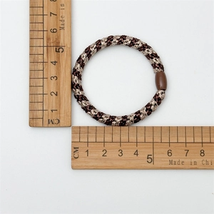 Elastic brown and gold woven hair tie with resin buckle, 5cm diameter measurement