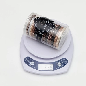 Close-up of hair ties in a jar on a scale weighing 55.9g for high ponytail support