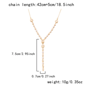 Detail view of gold Y-shaped necklace with zircon crystals and dimensions markers