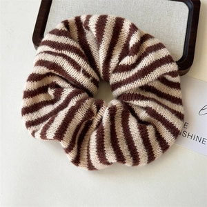 Brown and beige knitted striped scrunchie with soft autumn winter texture