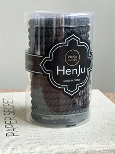 Detail view of high elasticity hair ties set in portable transparent cylinder packaging