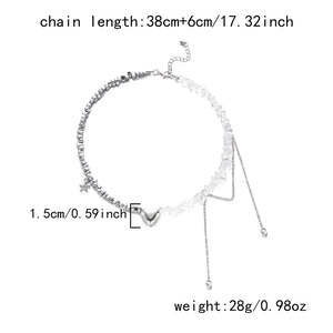 Detail of asymmetrical heart necklace with silver beads and faceted crystal chain