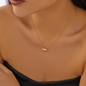 Elegant gold layered necklace with zircon pendant on a model's neck for a refined style