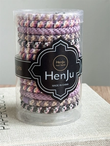 Close-up of durable elastic hair band set in a clear cylindrical storage container
