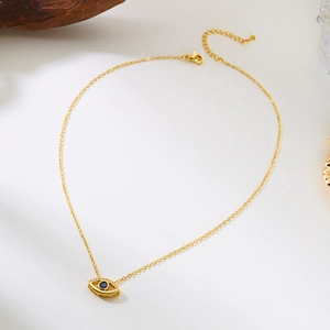 Detailed view of evil eye necklace with blue center stone and white crystals on gold chain
