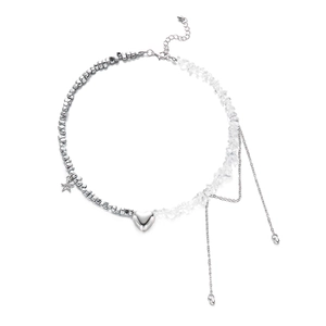 Detail showing asymmetrical necklace with heart pendants, metal beads and clear stones